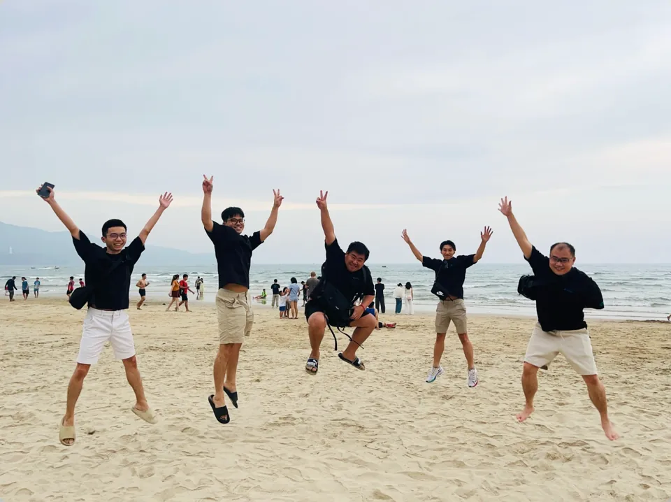 Cyberbot colleagues jumping on a beach